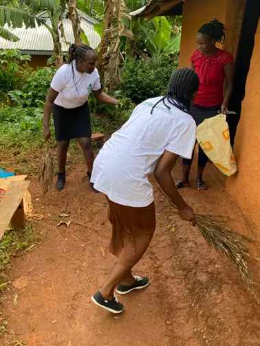 Action Smiles members cleaning Kemunto's compound