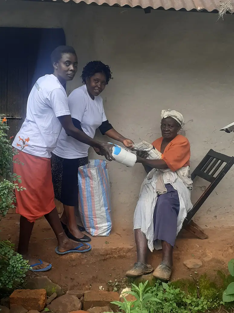 Priscilla Receiving food donation from Action Smiles International members